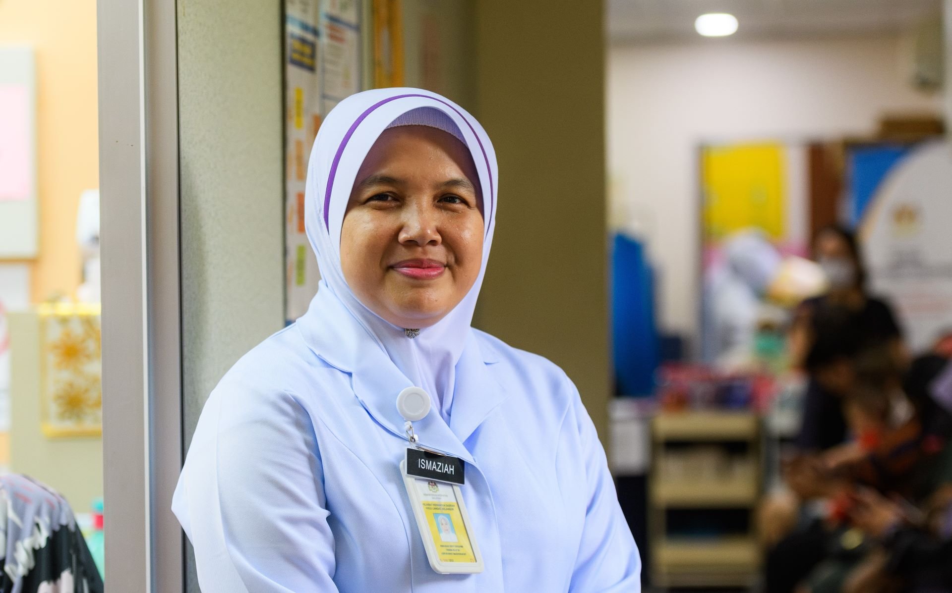 A community nurse and midwife stands in a clinic